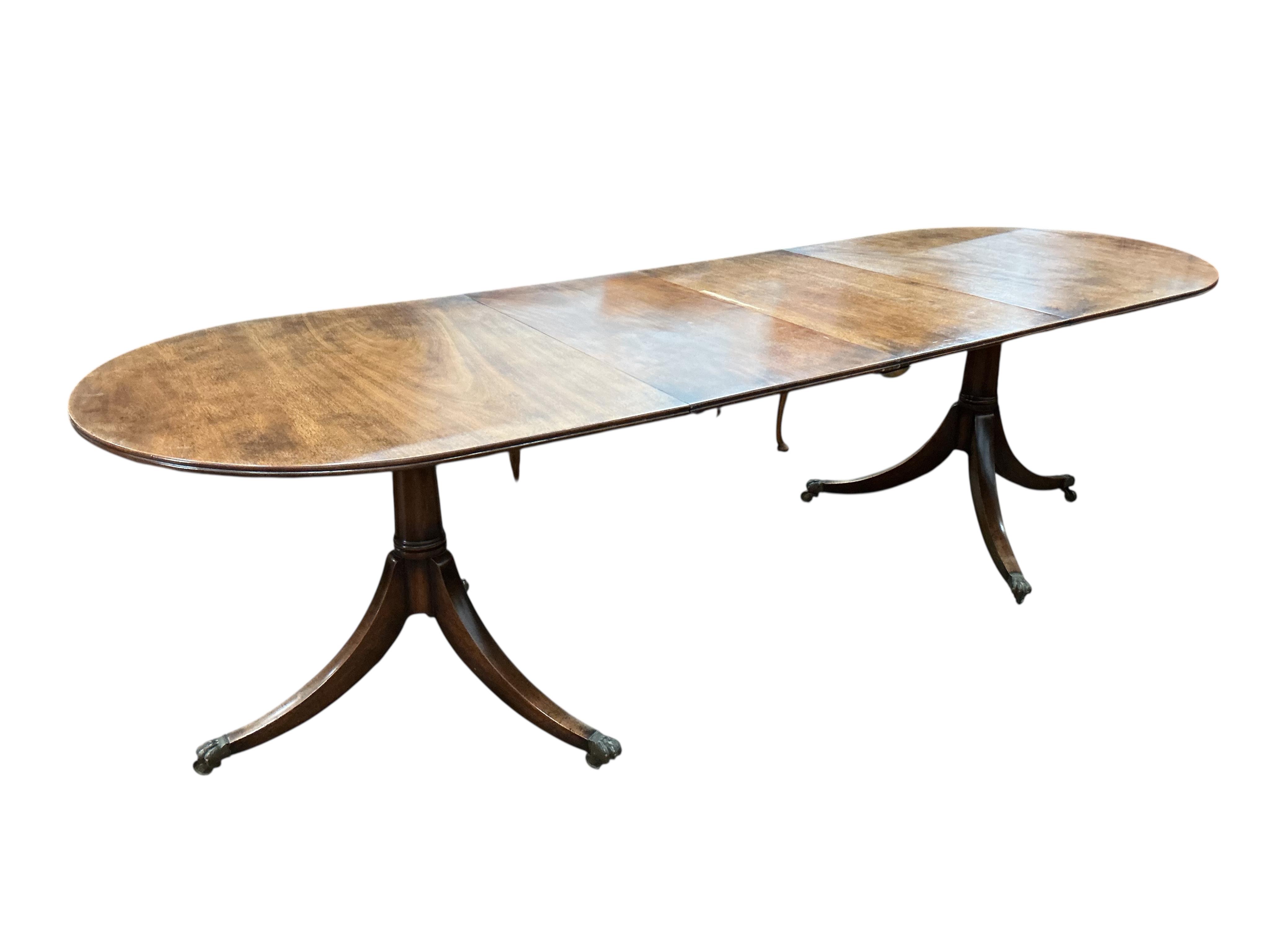 A George III style mahogany twin pillar 'D' end extending dining table, width 260cm extended, two spare leaves, depth 91cm, height 72cm